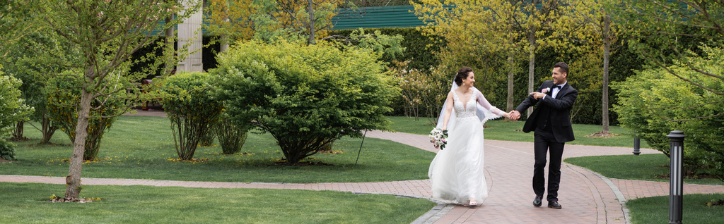 Mosolygó vőlegény ujjal mutogat menyasszony a parkban, banner  - Fotó, kép