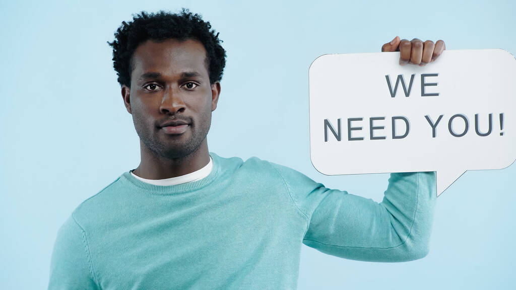 african american employer holding speech bubble with we need you lettering isolated on blue - Photo, Image