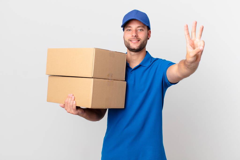 package deliver man smiling and looking friendly, showing number three - Photo, Image