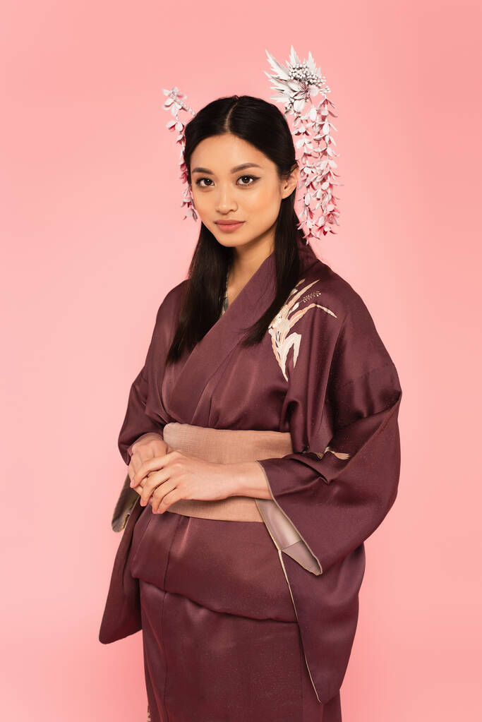 Asian woman in kimono and traditional kanzashi in hair isolated on pink  - Photo, Image