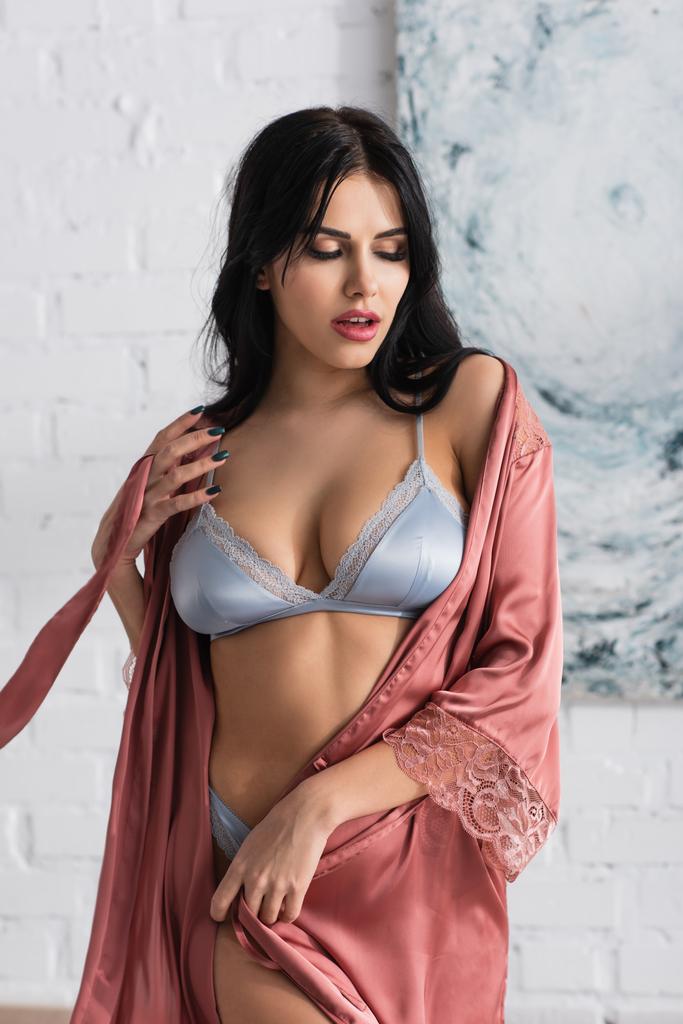 young seductive woman in bra and silk robe  - Photo, Image