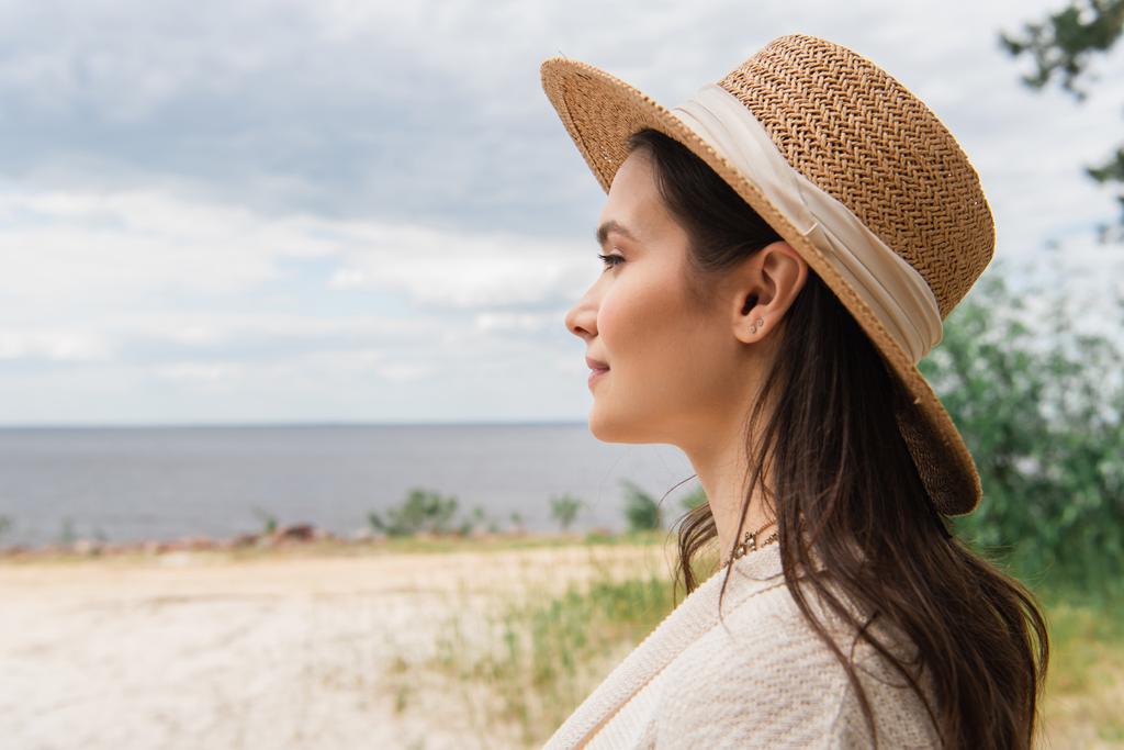 femme heureuse en chapeau de soleil près de la mer  - Photo, image