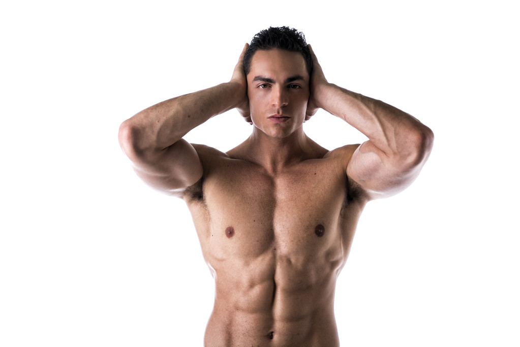 Muscular shirtless young man covering ears with hands - Photo, Image