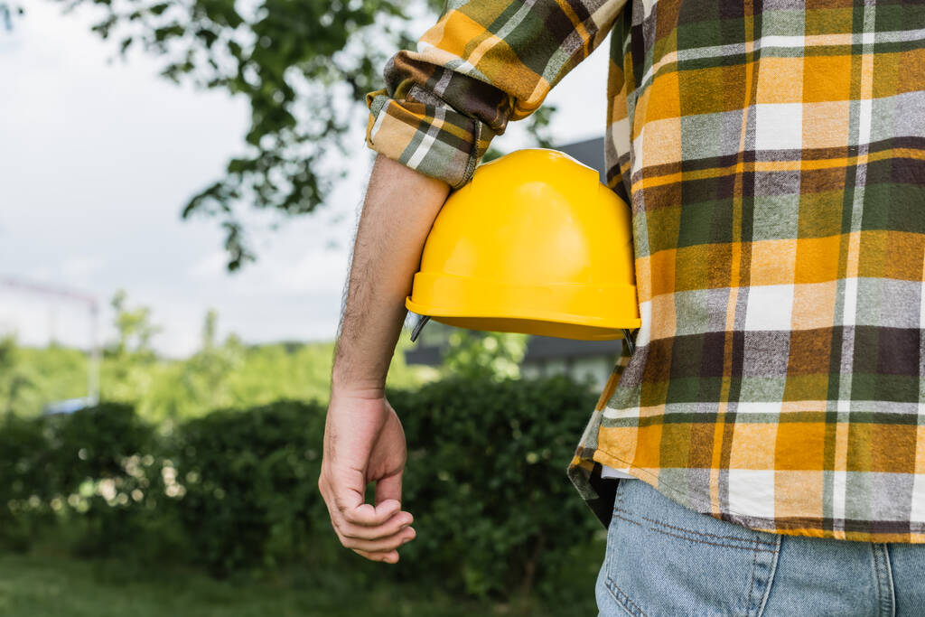 back view of cropped workman with hardhat outdoors, labor day concept - Photo, Image