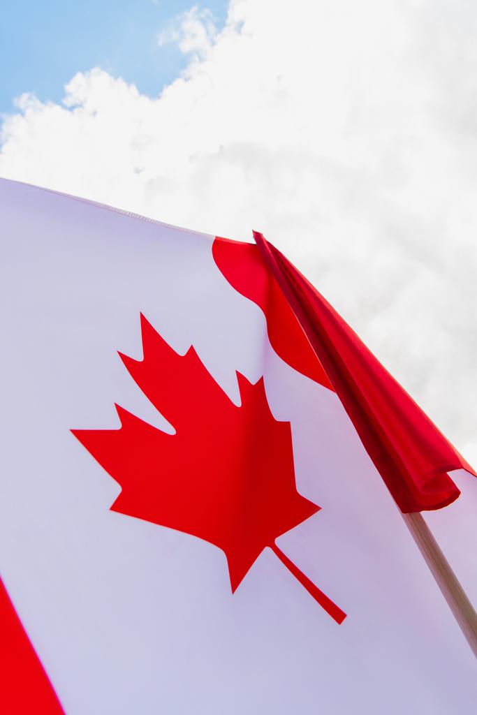 άποψη χαμηλής γωνίας της σημαίας του Καναδά με φύλλο σφενδάμου κατά του ουρανού  - Φωτογραφία, εικόνα
