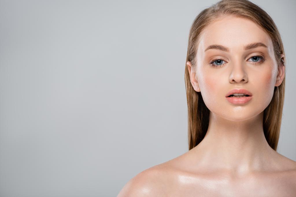 young woman with bare shoulders and perfect skin looking at camera isolated on grey  - Photo, Image