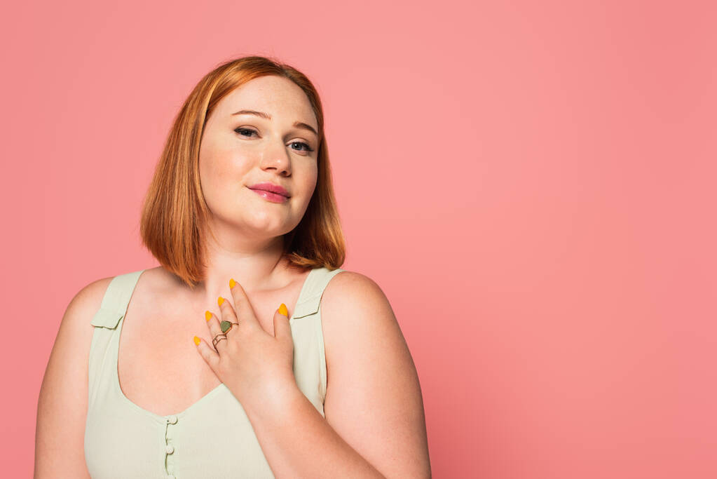 Plus size woman looking at camera isolated on pink  - Photo, Image