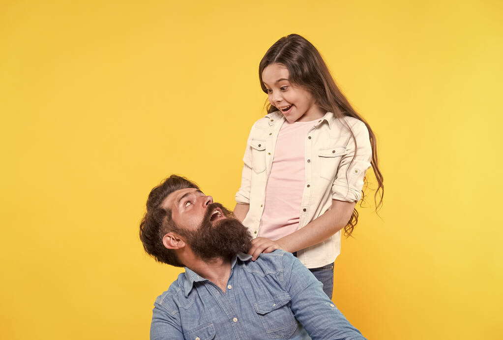 Father and happy little daughter having fun, surprise concept - Photo, Image