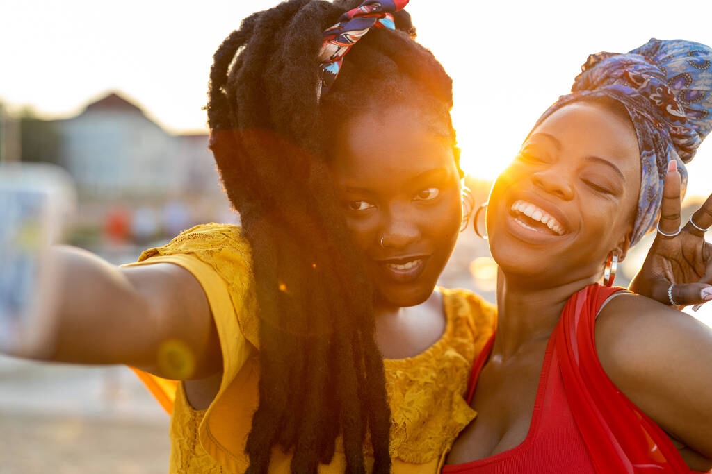 Happy young women enjoying the outdoors at sunset  - Photo, Image