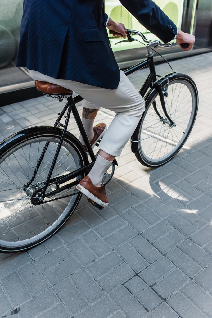 partial view of man riding bicycle outside - Photo, image
