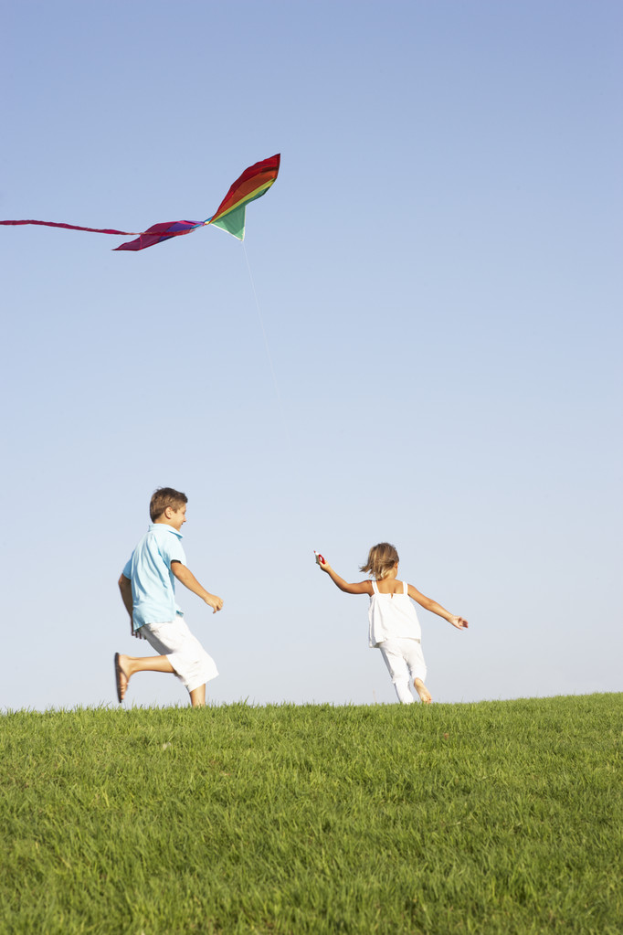 Young children run with kite through field - Photo, Image