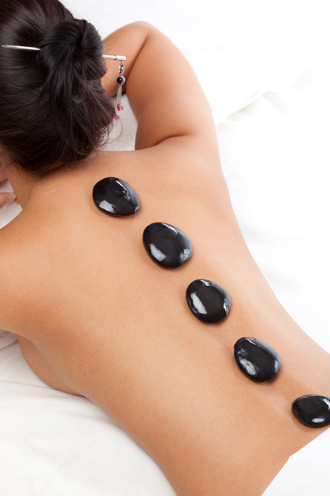Pretty woman receiving a therapy with hot stones - Photo, Image