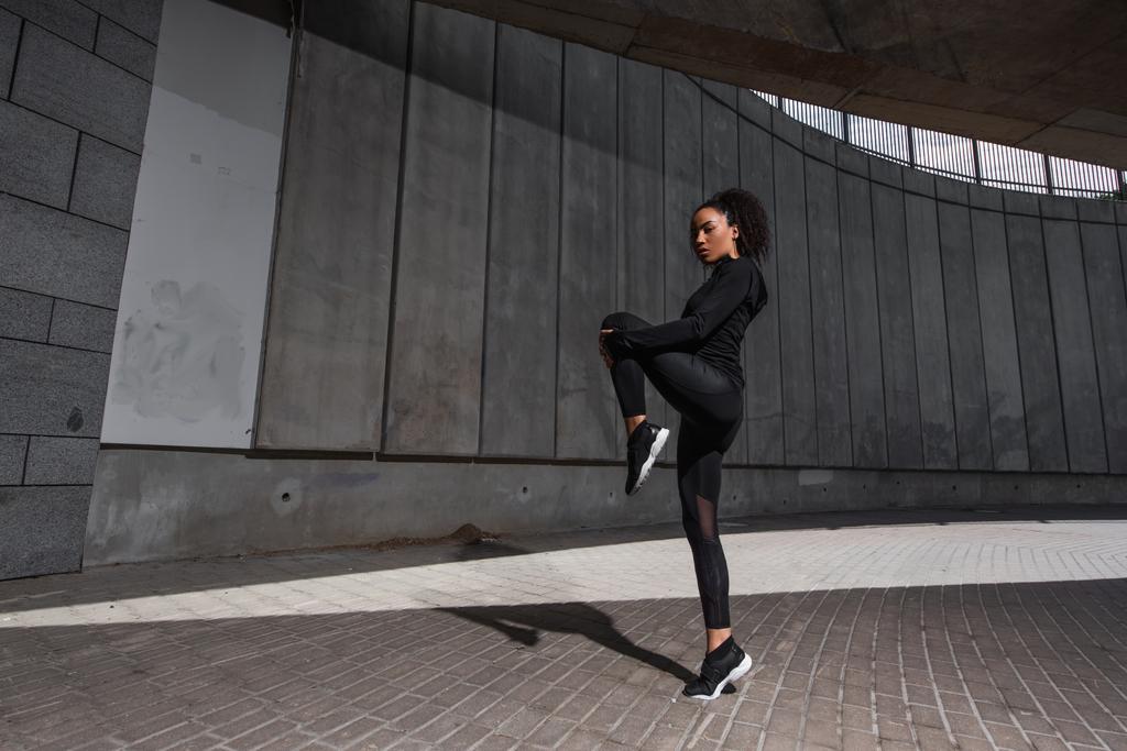 African american sportswoman exercising on urban street  - Photo, Image