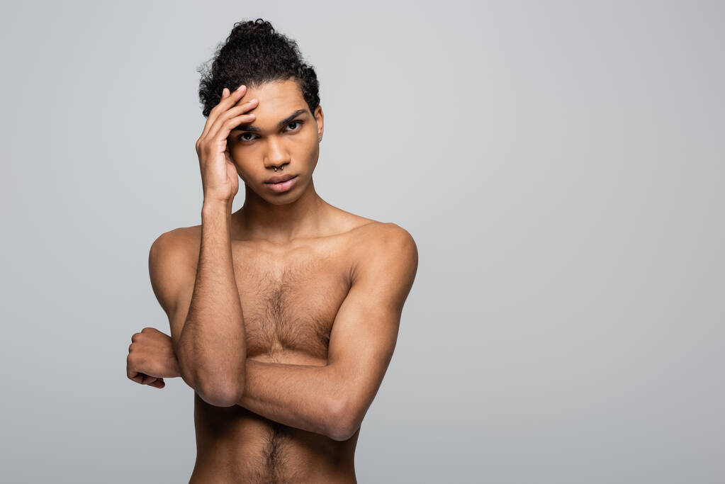 shirtless african american man holding hand near face while looking at camera isolated on grey, beauty concept - Photo, Image