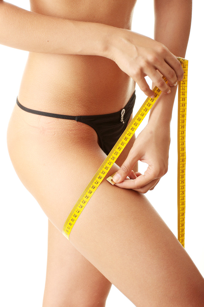 Slim woman measuring her leg - Photo, Image