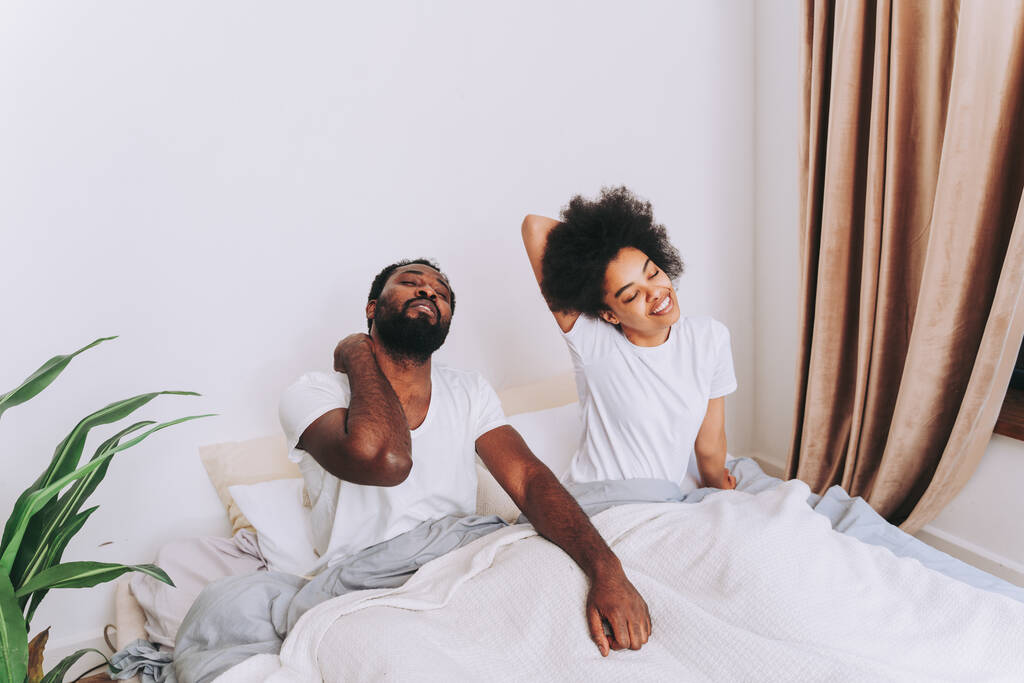 Afro amerykańska para w łóżku - prawdziwa piękna i wesoła para kochanków w domu - Zdjęcie, obraz