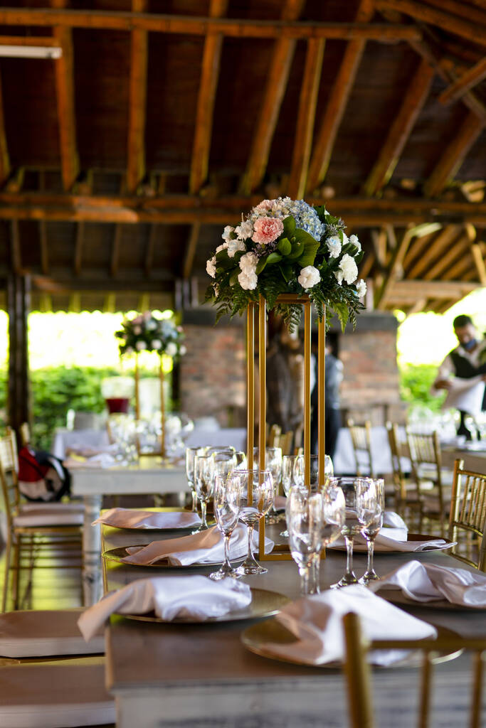 A selective focus shot of a beautiful table setting with a floral arrangement - Photo, Image