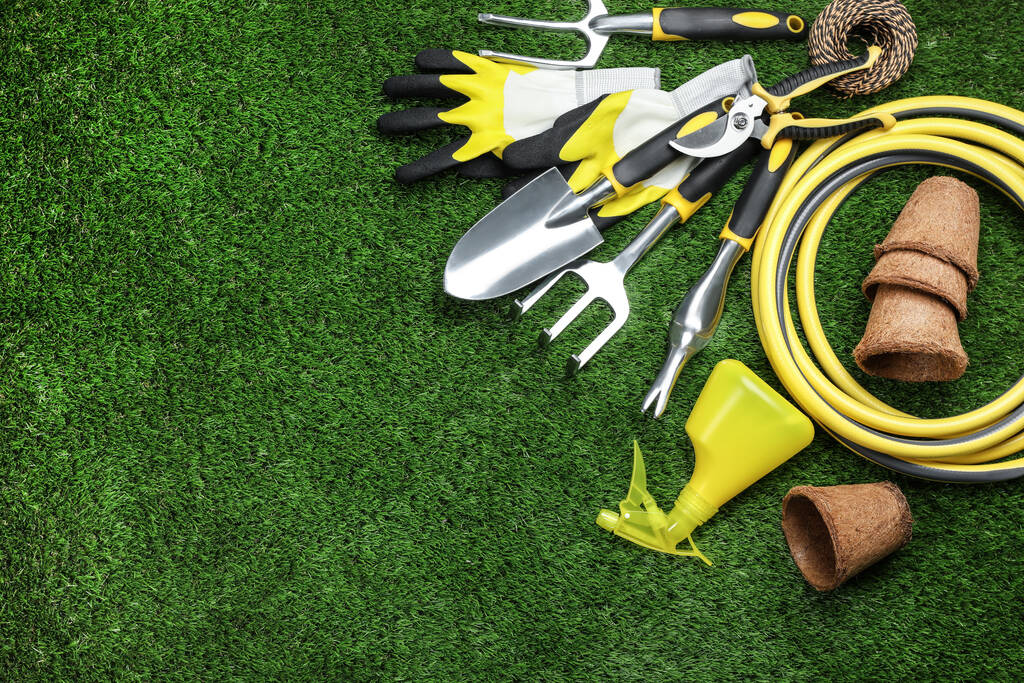 Flat lay composition with gardening tools on green grass, space for text - Photo, Image