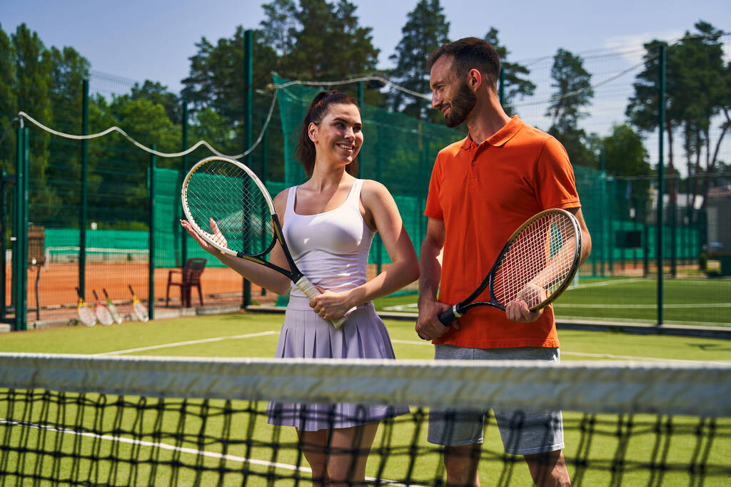Two sportspeople with rackets on the court - Photo, Image
