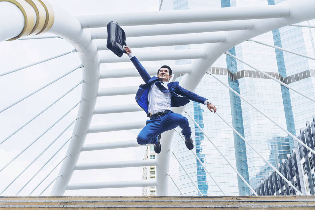 Energetic man happy jumping in air celebrating  success and achievement - Photo, Image