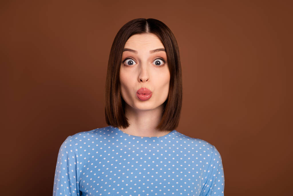 Photo of flirty brunette young lady blow kiss wear dotted shirt isolated on brown color background - Φωτογραφία, εικόνα