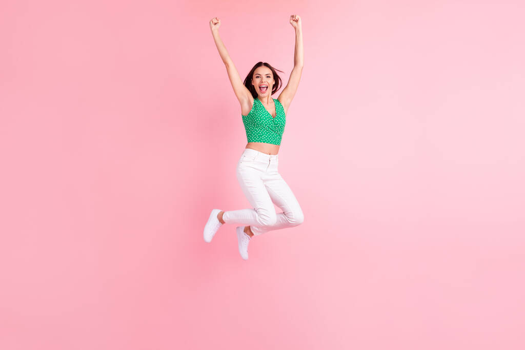 Full length body size photo smiling jumping up gesturing like winner happy overjoyed isolated pastel pink color background - Photo, Image