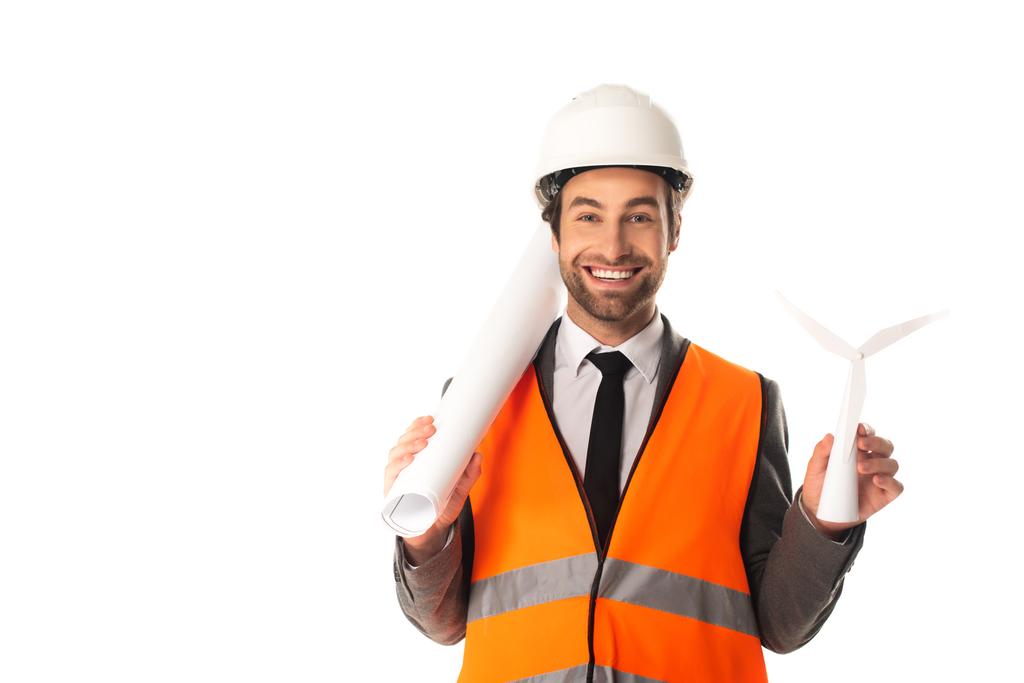 Smiling engineer with blueprint and model of wind turbine isolated on white  - Photo, Image