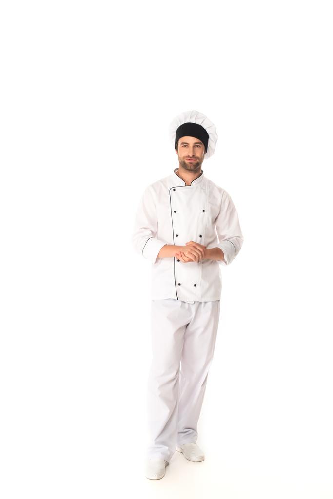 Volledige lengte van de chef-kok op zoek naar camera op witte achtergrond  - Foto, afbeelding