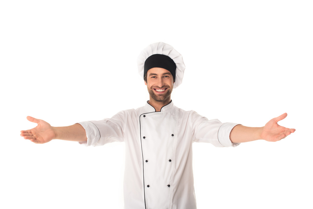 Ευτυχισμένος σεφ με απλωμένα χέρια κοιτάζοντας κάμερα απομονωμένη σε λευκό  - Φωτογραφία, εικόνα