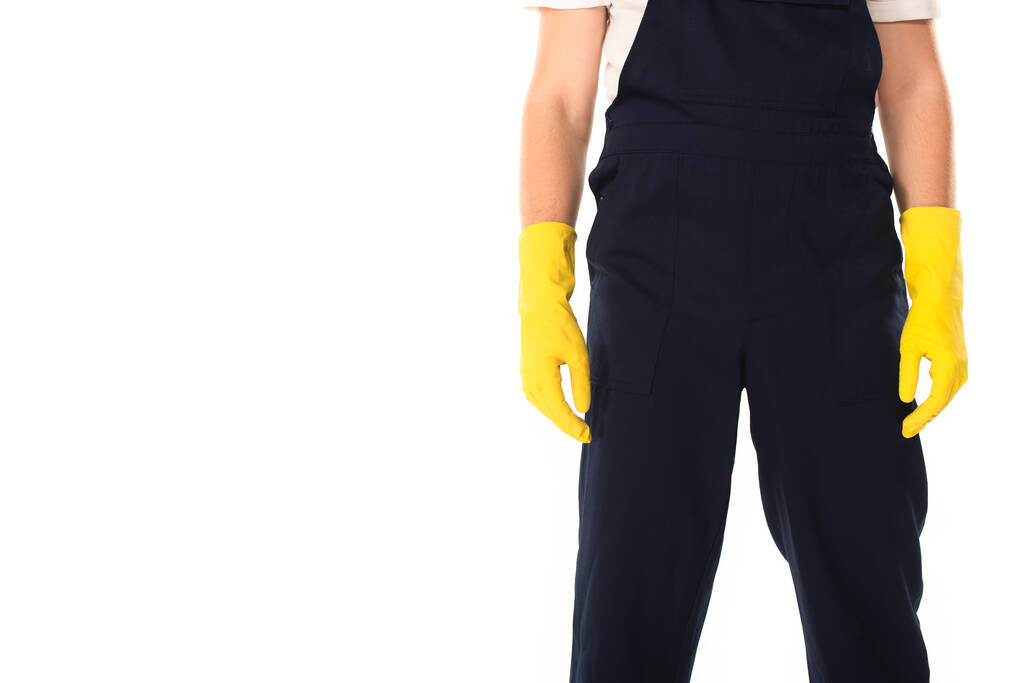 Vista recortada del limpiador en mono y guantes de goma aislados en blanco  - Foto, imagen