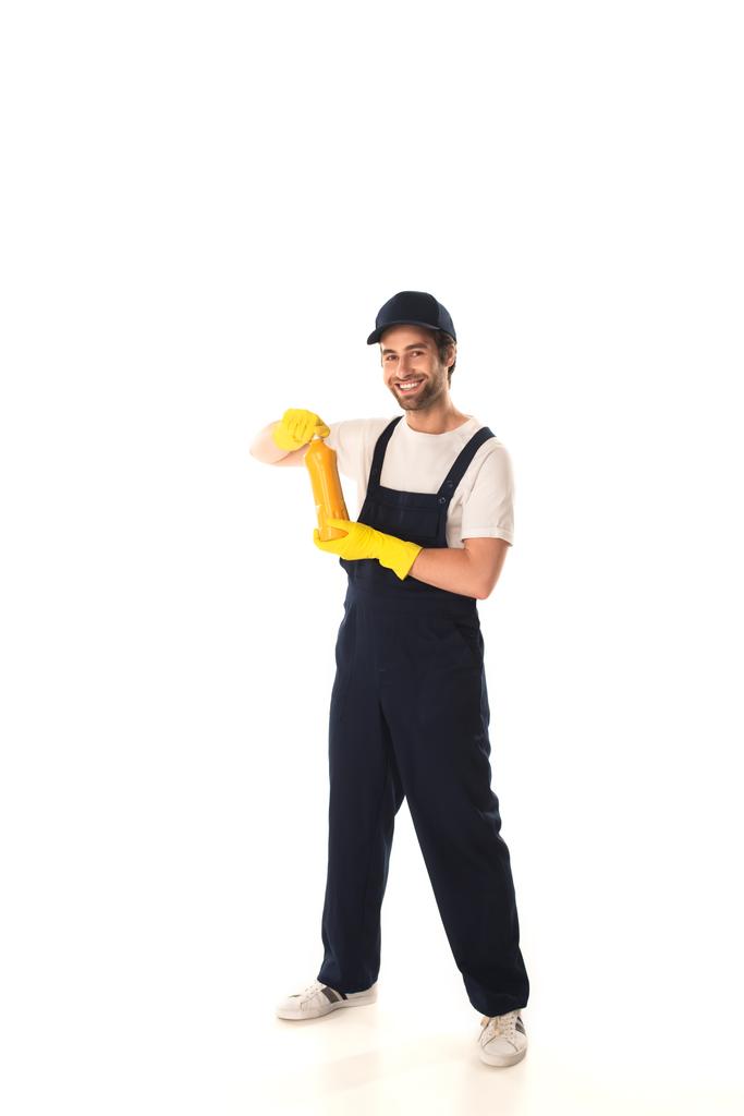 Positive cleaner holding detergent and looking at camera on white background  - Photo, Image