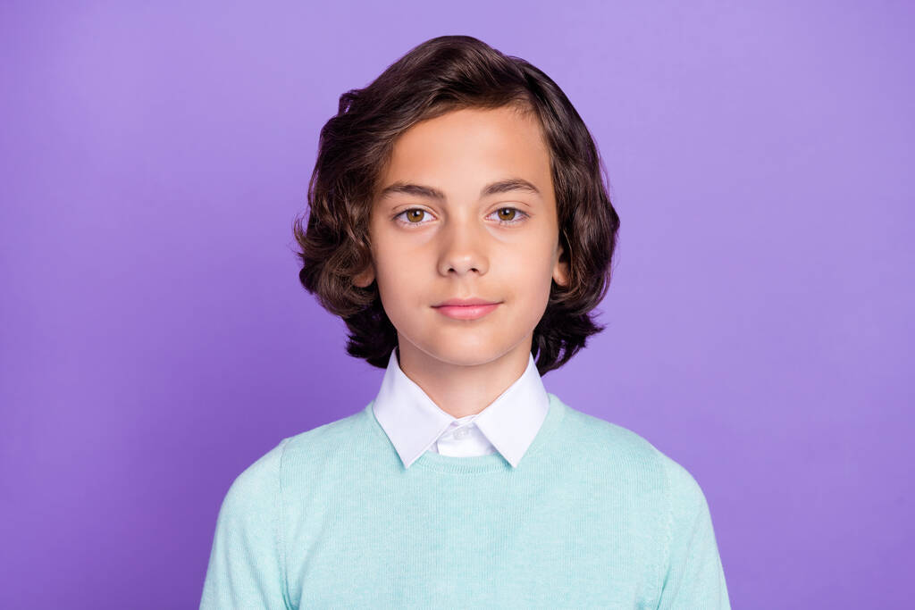 Photo of serious confident school boy wear turquoise sweater smiling isolated violet color background - Photo, Image