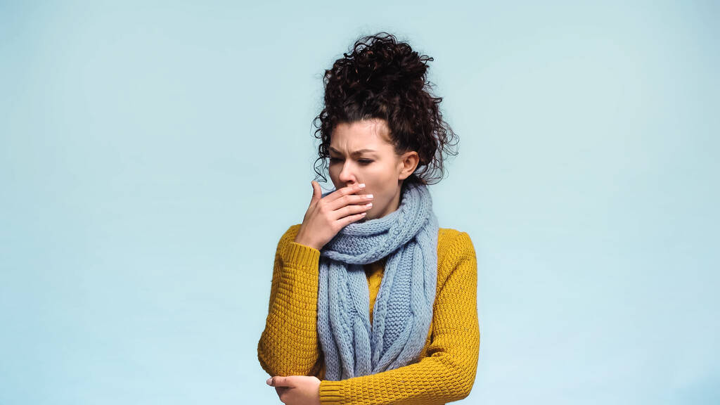 sick woman in warm scarf and sweater coughing isolated on blue - Photo, Image