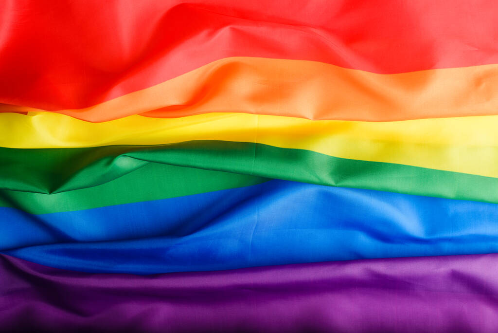 Top view duhová vlajka pozadí, mezinárodní symbol komunity LGBT, znamení rozmanitosti a rovnosti pohlaví v právech. - Fotografie, Obrázek