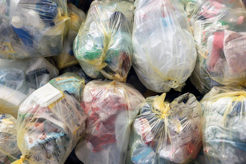 sacchetti di plastica con diversi tipi di rifiuti su sfondo bianco - Foto, immagini