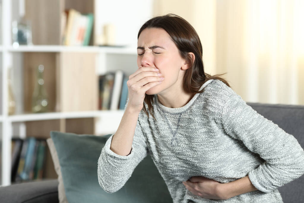 Woman with a stomach ache about to vomit at home - Photo, Image