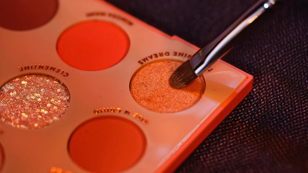 primer plano de cepillo cosmético cerca de sombra de ojos con letras de sueños de mandarina - Foto, Imagen