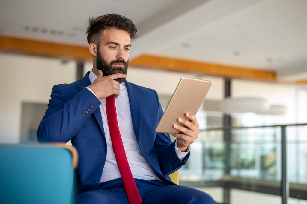 Hezký obchodník pracuje na svém tabletu v kanceláři - Fotografie, Obrázek
