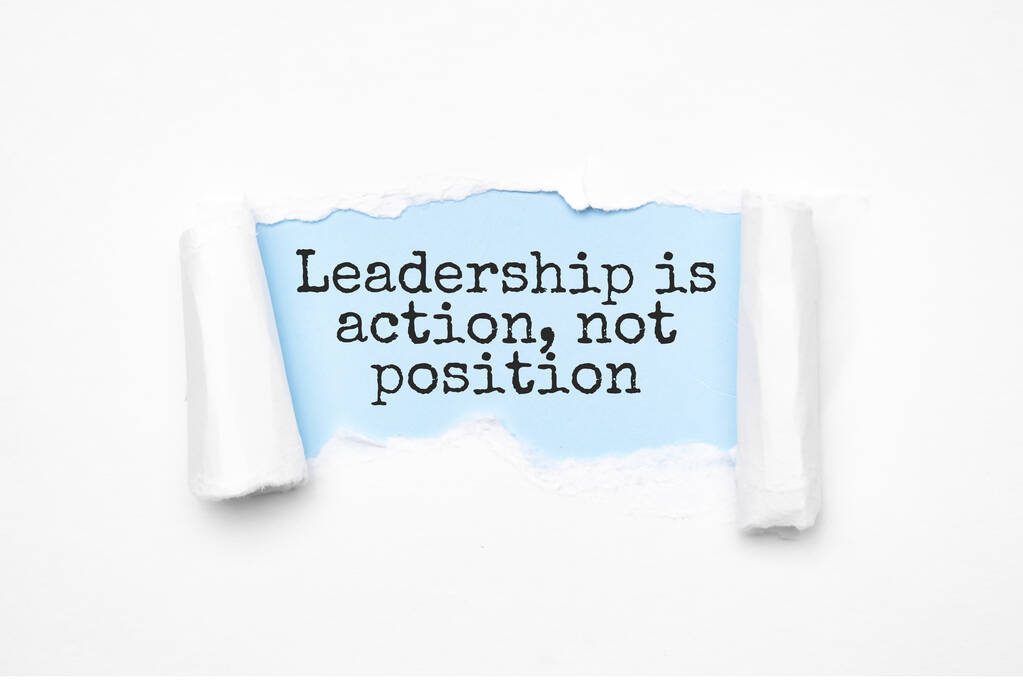 Concept of discovering Leadership is action, not position. Uncovered unrolled beige torn paper and search engine optimization abbreviation. - Photo, Image