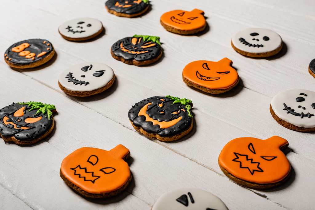 sweet and spooky pumpkin shape halloween cookies on white surface - Photo, Image