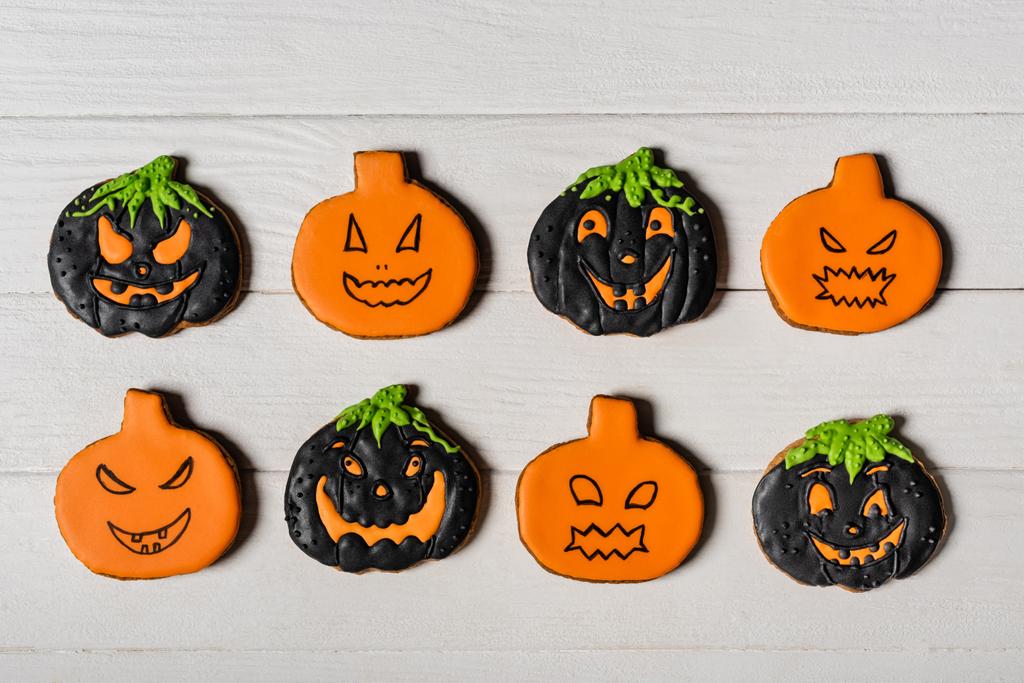 flay lay with spooky pumpkin shape halloween cookies on white surface - Photo, Image