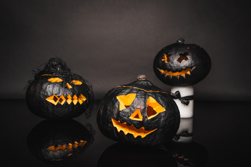veistetty ja tumma halloween kurpitsat mustalla pohjalla  - Valokuva, kuva