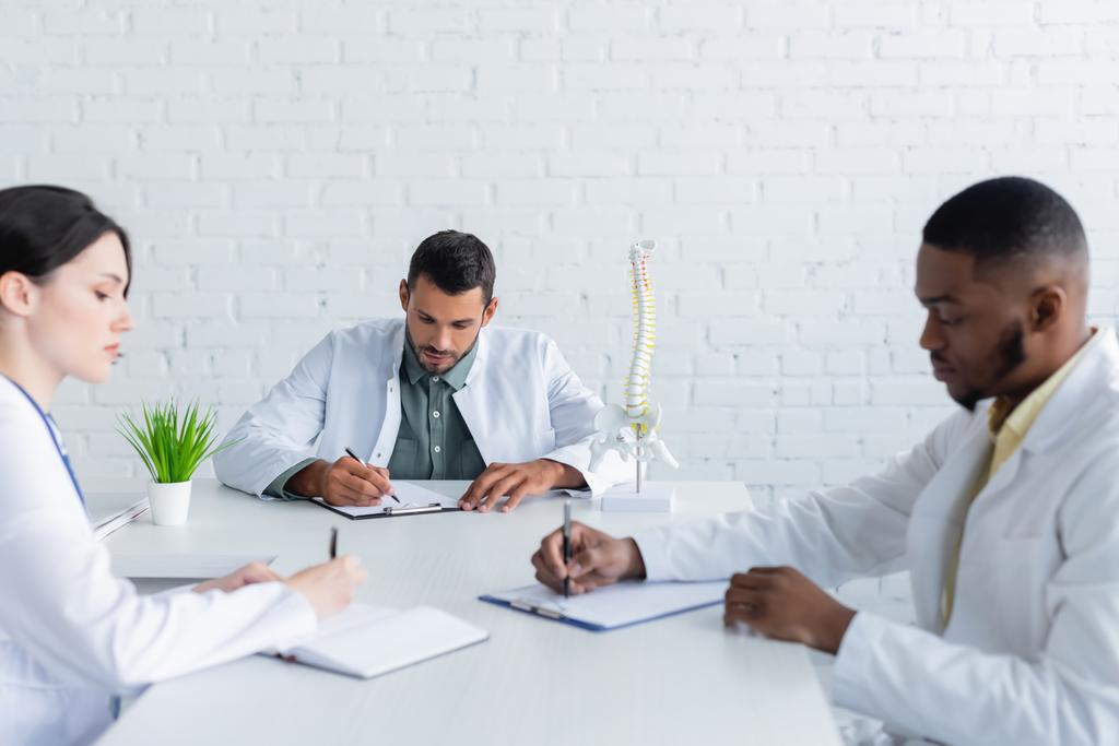 médicos multiétnicos que trabajan con papeles en la sala de reuniones - Foto, Imagen