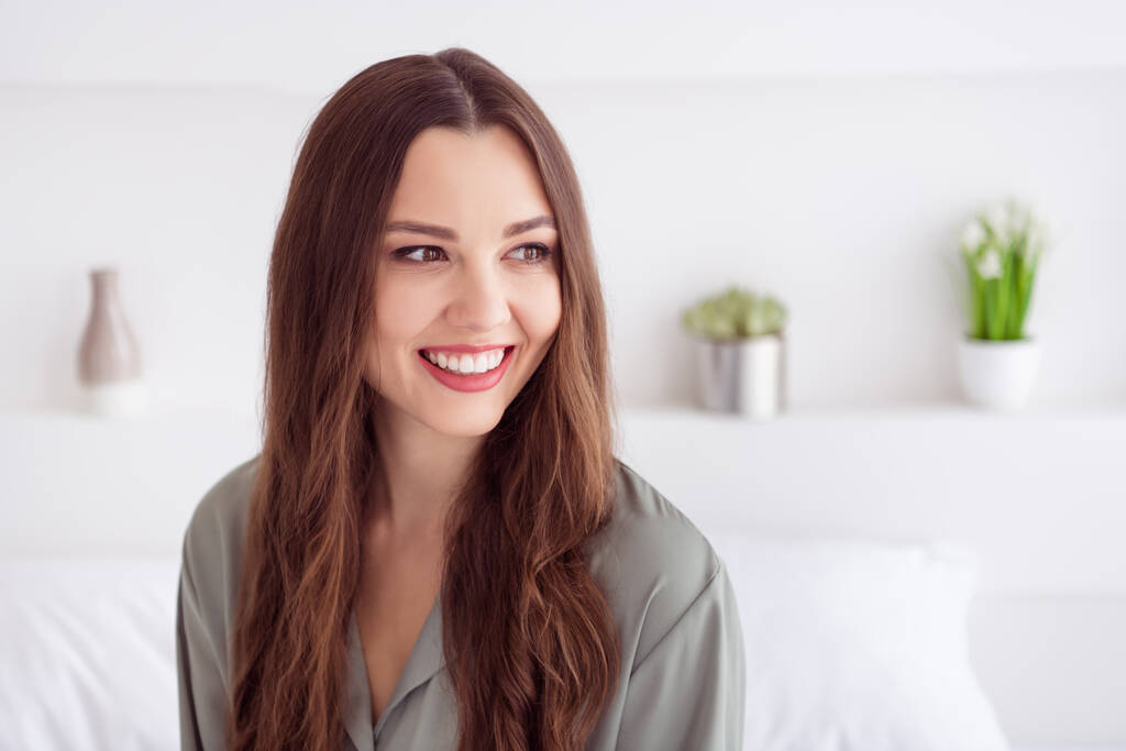 Portrait of attractive dreamy cheerful girl sitting on bed spending day weekend at home house light white interior - Photo, Image