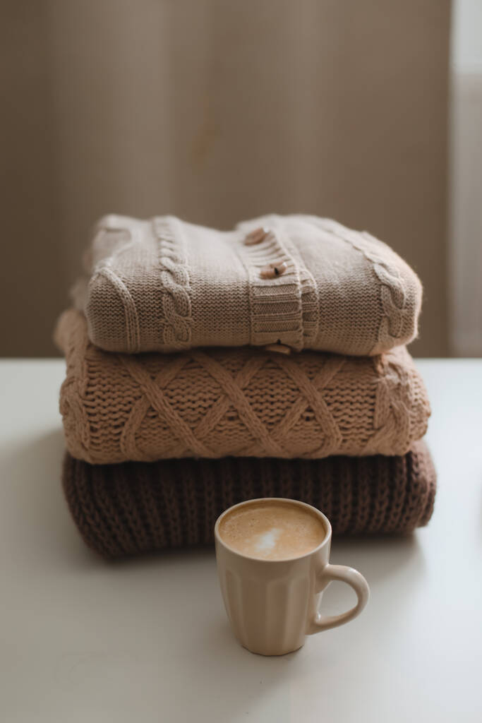 cozy comfortable hygge home atmosphere and still life with a cup, candle and sweaters - Photo, Image