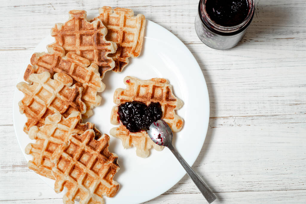 Belgian cottage cheese waffles with berry jam on a white plate. - Photo, Image