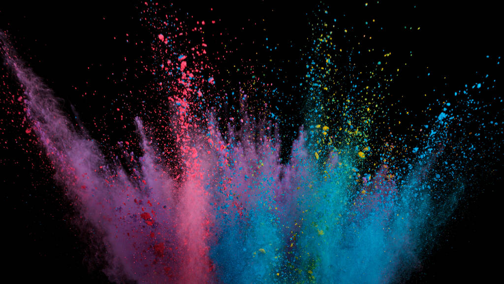 Freeze motion shot di esplosione di polvere di colore isolato su sfondo nero. - Foto, immagini