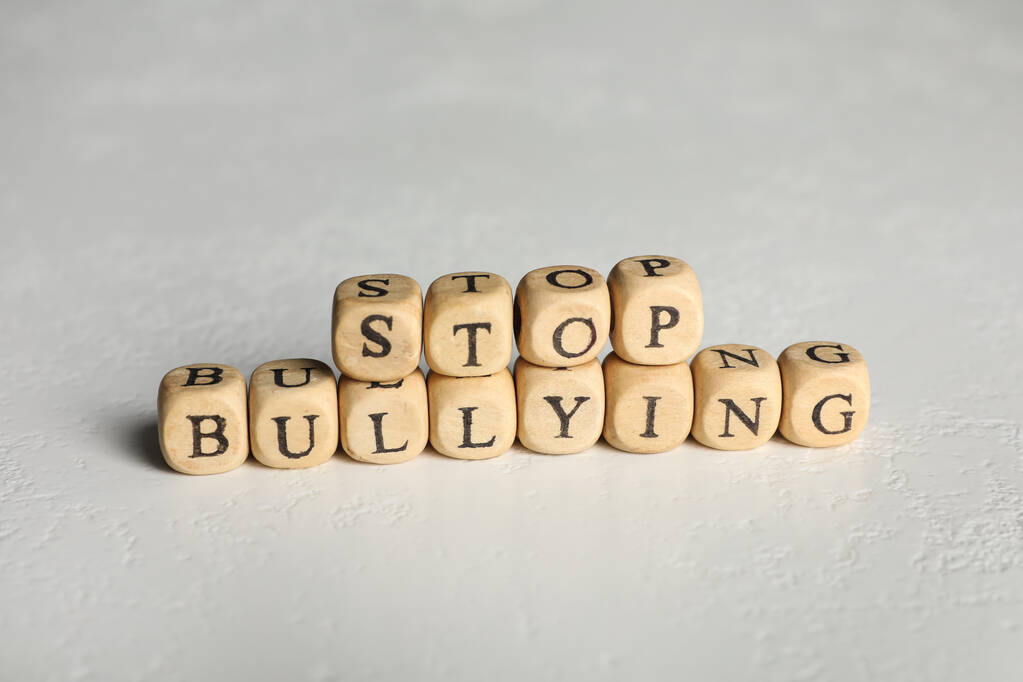 Phrase Stop Bullying made of wooden cubes with letters on stone surface, closeup - Photo, Image