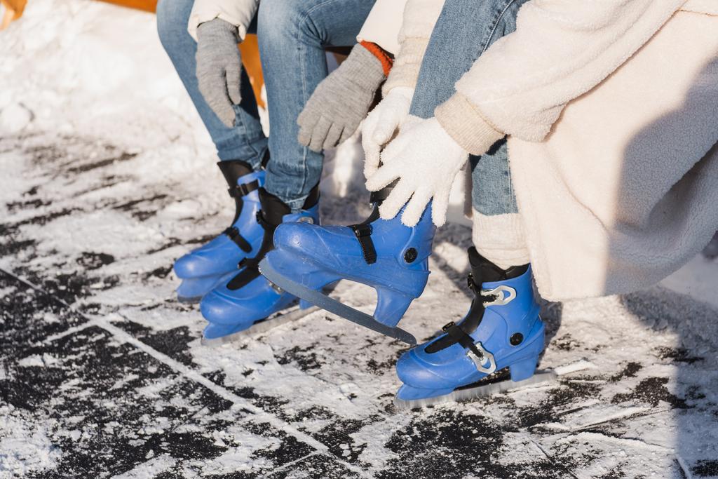 cropped view of couple wearing ice skates  - Photo, Image
