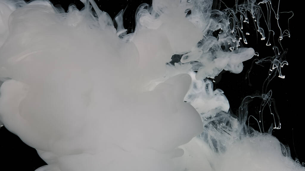 Abstract background. White cloud of milky ink. Black and white fantastic art. White watercolor ink in water on a black background. - Photo, Image